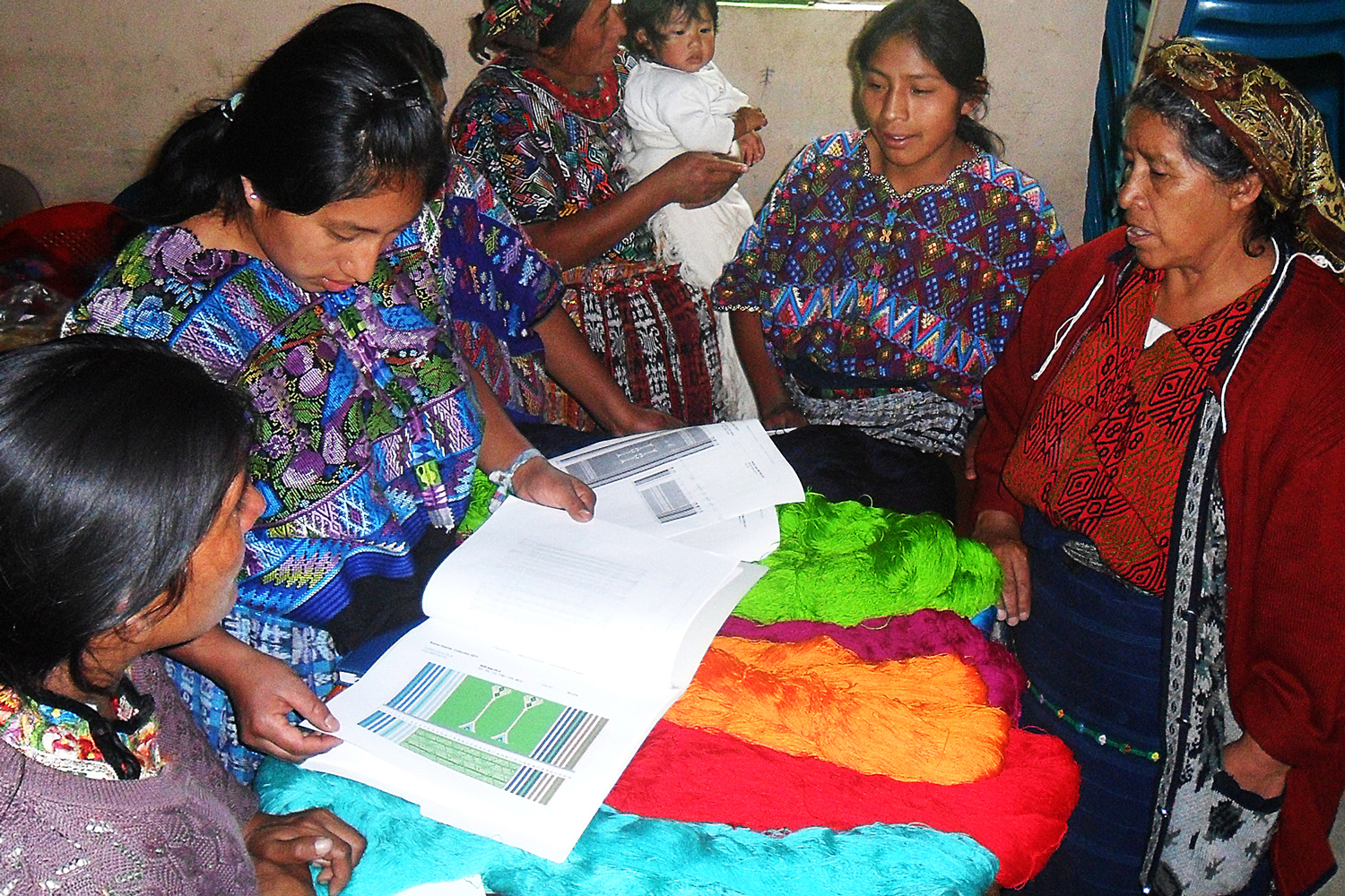 Weavers studying the new designs to produce
